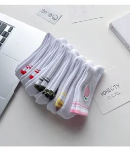 White mid-tube socks detail view, featuring colorful striped cuffs and cute embroidery for daily wear.