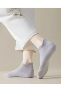 Close-up detail of lightweight summer ankle socks in light grey, soft and breathable fabric.