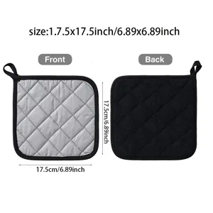 Detailed view of kitchen pot holder, grey and black quilted fabric with hanging loop.