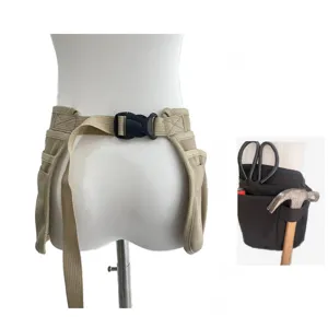 Close-up detail view of multi-pocket tool waist apron with adjustable buckle strap.