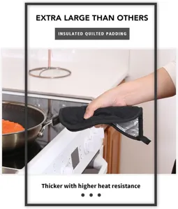 Detailed view of black quilted heat resistant kitchen oven mitt pot holder for safe cooking.