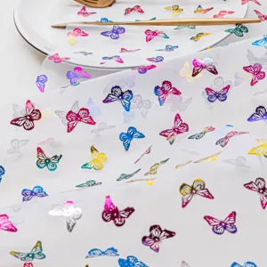 Colorful butterfly tablecloth detail shot, sheer fabric dining table mat for party kitchen decor.
