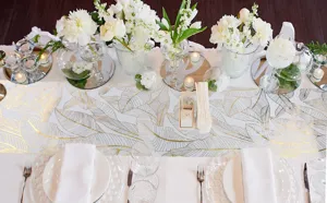 Chemin de table doré à motif de feuilles, décor de mariage chatoyant en tissu maille.