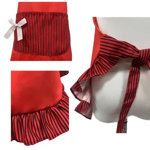 Red and black striped cute kitchen apron detail view featuring white bow and ruffles.