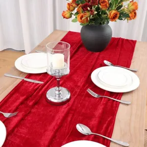 Red velvet table runner detail showcasing soft fabric texture and elegant European dining table decor.
