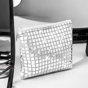 Silver sequin cosmetic bag detail view, sparkling makeup pouch zipper closure storage.