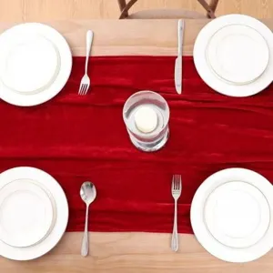 Red velvet table runner detail shot, European style decor for wedding party banquet dining table.