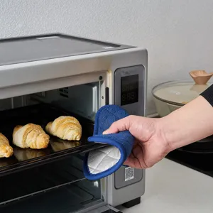 Detailed view of blue kitchen oven mitt showcasing heat-resistant silver lining for baking use.