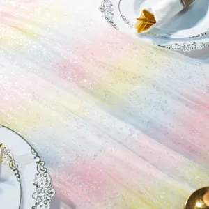 Close-up detail of the pink yellow blue gradient sparkly tulle table runner in a party setting.