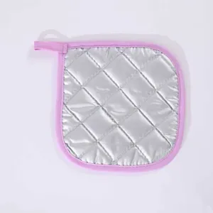 Silver coated kitchen heat resistant pad with pink edge and hanging loop for baking cooking.