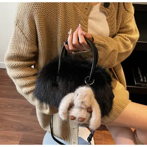 Detailed view of the fuzzy black Boston bag featuring a cute beige rabbit fur charm.