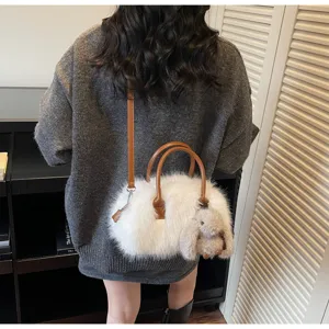 White faux fur Boston bag with plush bunny charm for autumn winter outfit style