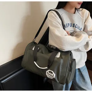Large capacity olive green travel duffel bag carried by a person in a casual setting