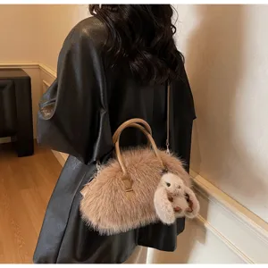 Detailed view of the fluffy faux fur texture on a brown Boston commute bag.