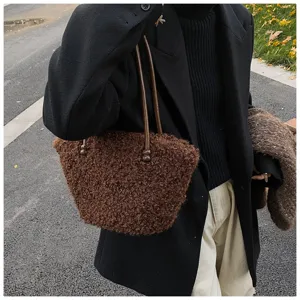 Detail of brown faux lamb wool shoulder bag featuring fluffy texture and slim straps