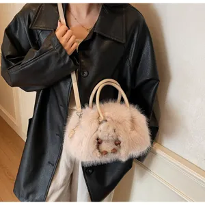 Chic faux fur plush Boston bag in light pink styled with a black leather coat