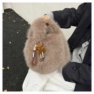 Close-up detail of the autumn winter fluffy plush handbag, stylish brown fur tote bag.