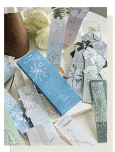 Macro view of vintage embossed floral bookmarks with silver foil detailing