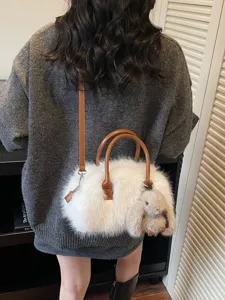 Elegant white faux fur Boston bag with plush rabbit charm and brown leather handles