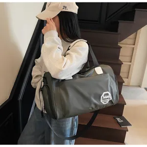 Large capacity olive green waterproof travel duffel bag shown carried by a model