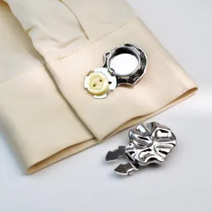 Close-up detail view of metal shirt button cover and stylish decorative turtle clip accessory.