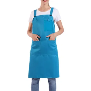 Blue polyester work apron detail, featuring adjustable cross-back straps and multiple handy pockets.