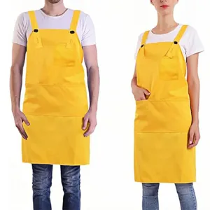 Yellow adjustable shoulder work apron detail view with chest pocket and durable fabric.