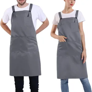 Adjustable polyester work apron with cross back and multiple pockets for restaurant staff.