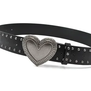 Close-up detail of the black PU leather belt with metal studs and ornate heart buckle.