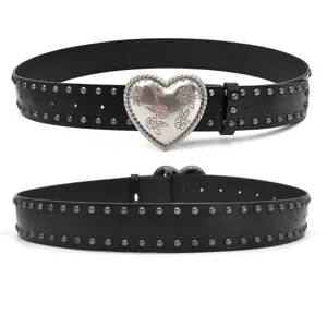 Black studded leather belt featuring a large silver heart buckle with floral engravings.