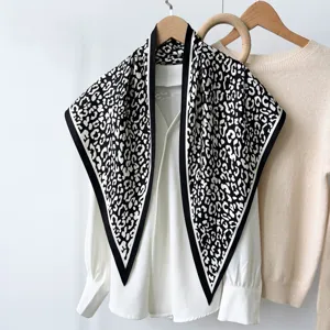 Detailed close-up of the black and white printed triangular scarf showing fabric texture.
