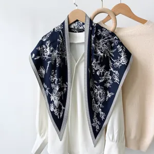 Detailed shot of retro navy blue floral triangular scarf with elegant striped border style.