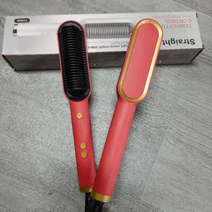Pettine piastra per capelli elettrico rosso e oro con la sua confezione di vendita al dettaglio