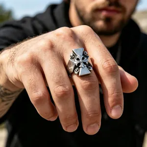 Gothic vintage stainless steel skull and cross ring showcased on a male model hand