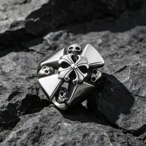 Gothic titanium steel ring featuring cross and skull designs on volcanic rock background.