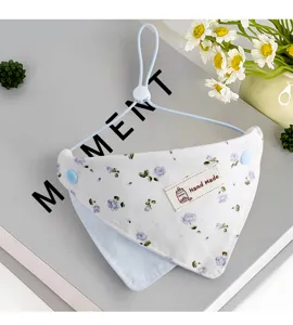 Floral pet bandana detail showing soft cotton fabric, adjustable strap, and handmade label.