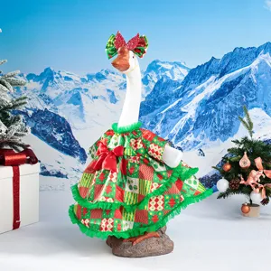 Detailed view of Christmas porch goose outfit with festive red green dress and bow for holiday decor.