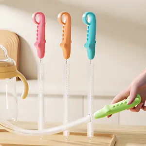 Flexible silicone straw cleaning brush set with cute cartoon handle for baby bottles and cups.