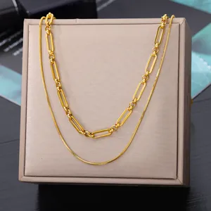 Elegant double layer gold necklace featuring paperclip and snake chain design for women.