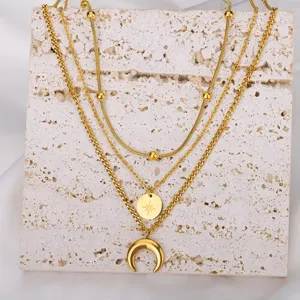 Multi-layer gold layered necklace with moon and star pendants, stylish clavicle chain for women.