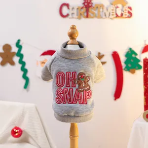 Grey pet sweater detail view, cozy winter knit apparel with cute gingerbread embroidery design.