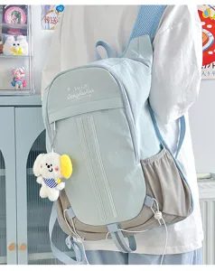 Detail view of Korean style student backpack, large capacity canvas school bag with cute dog pendant.