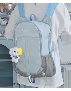 Cute aesthetic student backpack in light blue, featuring front zip pocket and side mesh storage.