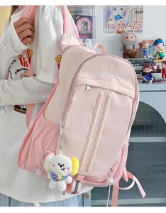Pink college style backpack detail shot, large capacity canvas school bag for students daily use.