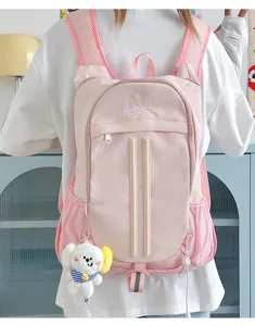 Cute pink college style backpack for students, large capacity casual daypack with plush charm.