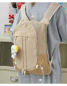 Casual canvas backpack in khaki, featuring front utility pockets and mesh side pockets.
