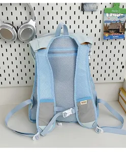Light blue college style backpack detail showing breathable mesh back panel and adjustable straps.