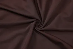 Detailed shot of dark brown ribbed knit fabric texture, showing soft drape and fine lines.