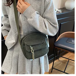 Detailed view of a stylish dark green corduroy crossbody bag for women and girls daily wear.