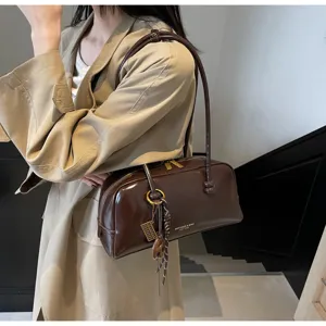 Detail view of the brown patent leather underarm pillow shoulder bag, vintage style.